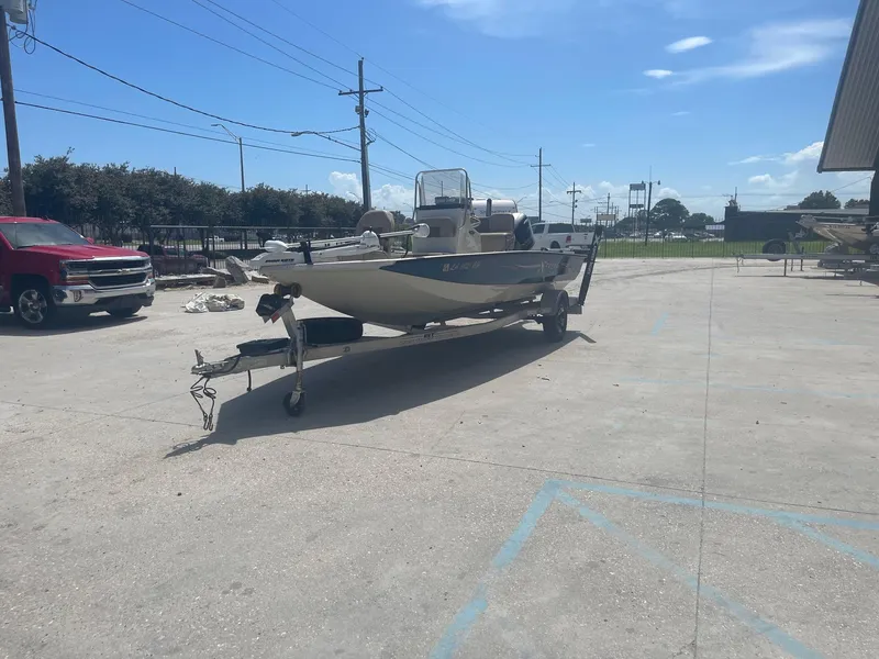 Slide: The Image of 2018 Express H20 Bay boat on trailer in parking lot under clear sky. - 3