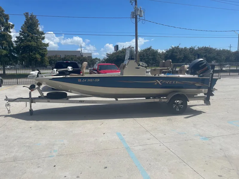 Slide: The Image of 2018 Express H20 Bay boat on trailer in parking lot. - 4