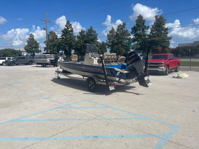 Slide: The Image of 2018 Express H20 Bay boat on a trailer in a parking lot. - 5