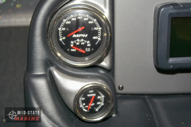 Slide: The Image of 2024 Triton 18 TrX boat dashboard with speedometer and water pressure gauge. - 13