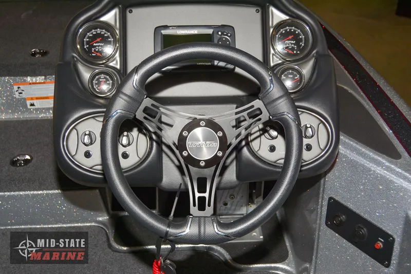 Slide: The Image of 2024 Triton 18 TrX boat dashboard with steering wheel and gauges - 14
