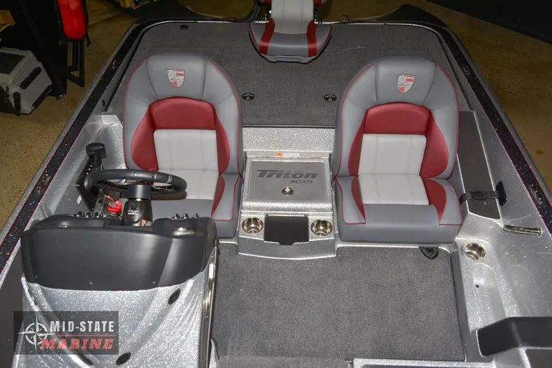 Slide: The Image of 2024 Triton 18 TrX boat interior with dual seats and steering console. - 16