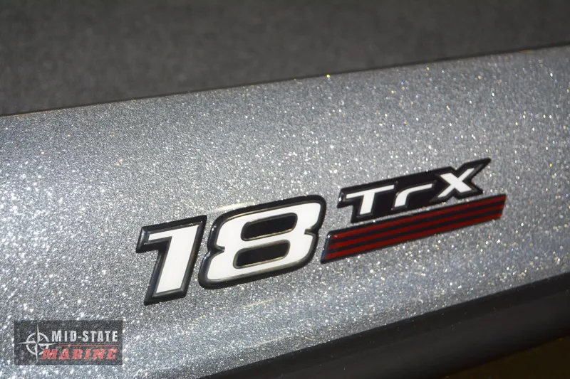 Slide: The Image of 2024 Triton 18 TrX boat model logo on metallic surface - 19