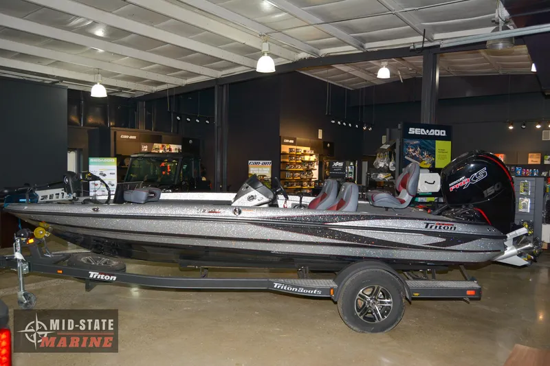 Slide: The Image of 2024 Triton 18 TrX bass boat on display at Mid-State Marine showroom. - 3