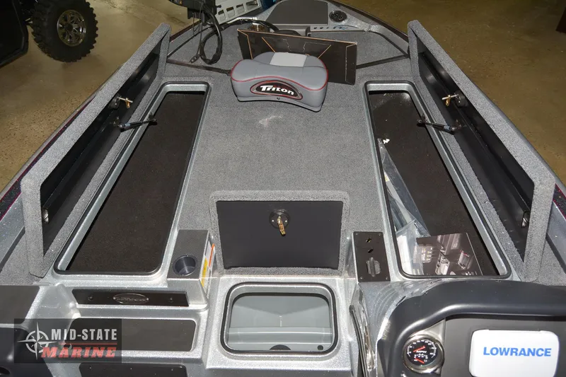 Slide: The Image of 2024 Triton 18 TrX boat interior with storage compartments and Lowrance electronics. - 4