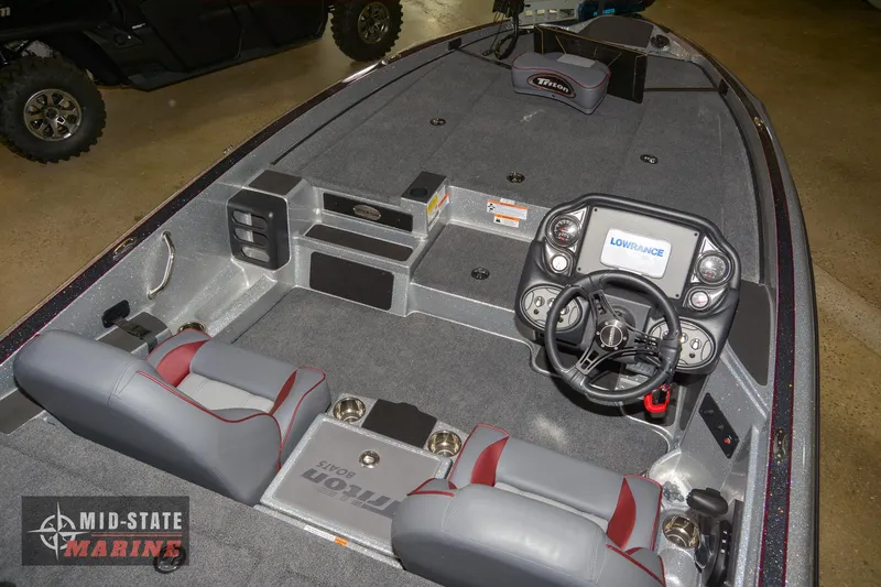 Slide: The Image of 2024 Triton 18 TrX boat interior with steering console and seating. - 5