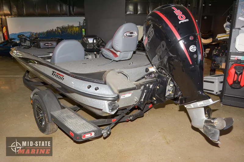 Slide: The Image of 2024 Triton 18 TrX boat on display at Mid-State Marine showroom. - 8