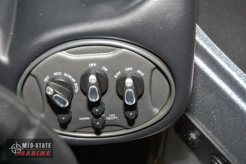 Slide: The Image of Control panel of 2024 Triton 18 TrX boat with switches and 12V receptacle. - 9