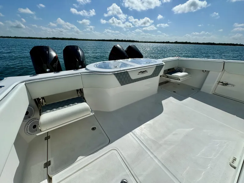 Slide: The Image of 2022 Invincible 40 Catamaran boat deck with triple outboard motors on a sunny day. - 11