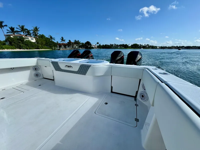 Slide: The Image of 2022 Invincible 40 Catamaran on calm waters with scenic shoreline in the background. - 12