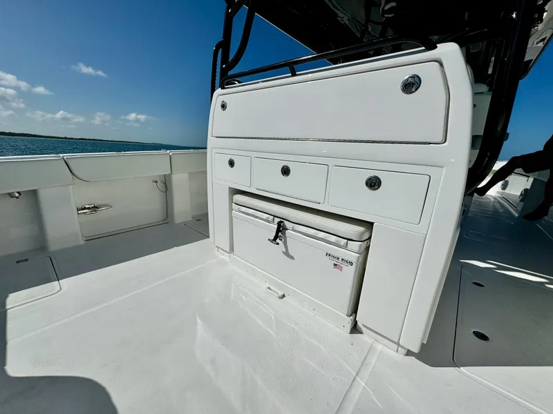 Slide: The Image of 2022 Invincible 40 Catamaran deck with storage compartments and cooler. - 17