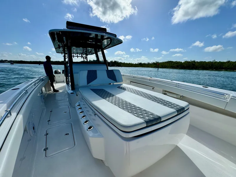 Slide: The Image of 2022 Invincible 40 Catamaran on water with sunpad and seating. - 19