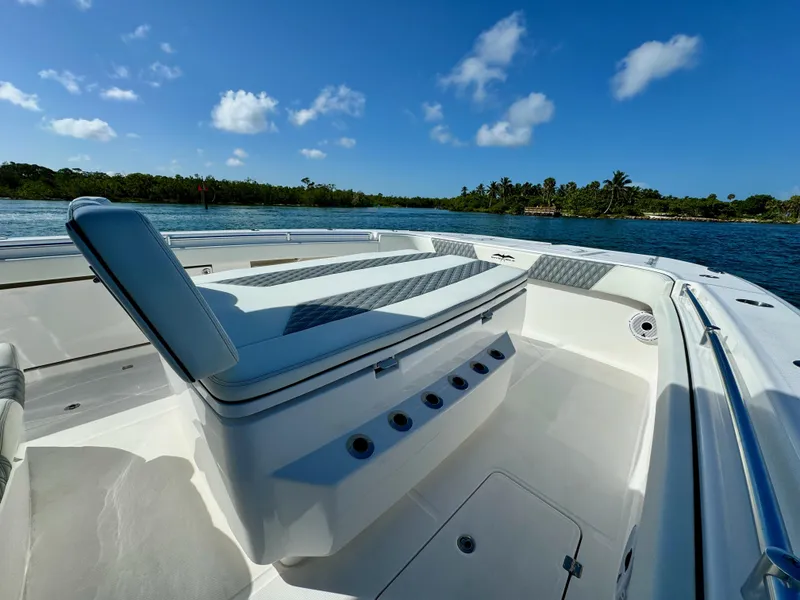 Slide: The Image of 2022 Invincible 40 Catamaran interior with seating, on a sunny day by the water. - 22