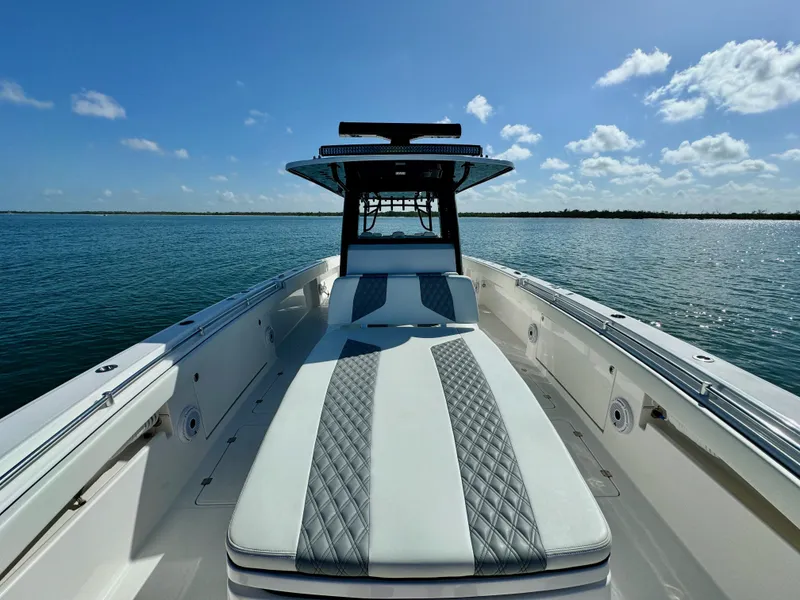 Slide: The Image of 2022 Invincible 40 Catamaran on calm waters under a clear blue sky. - 23