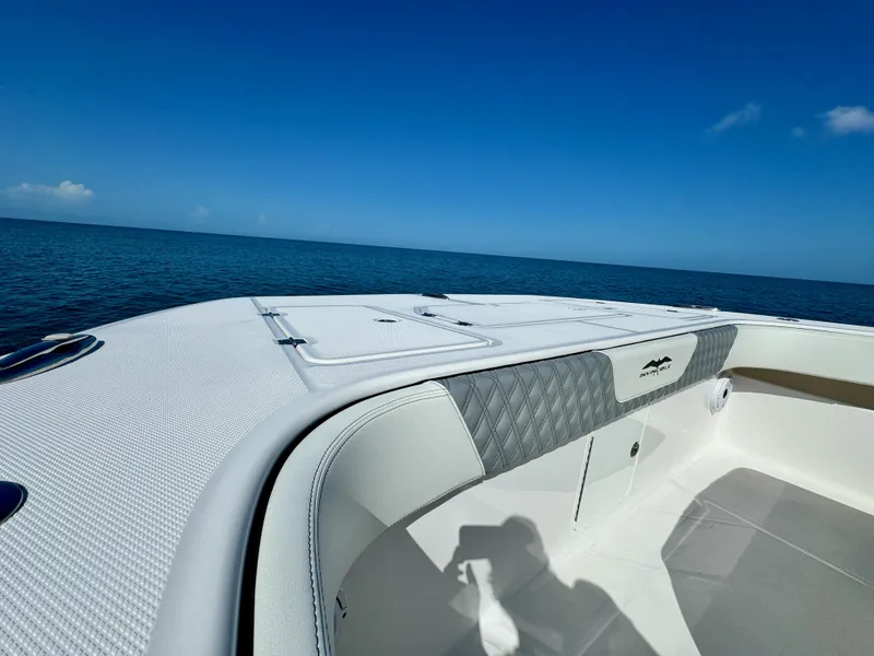 Slide: The Image of Invincible 40 Catamaran 2022 bow view on open water under clear blue sky. - 25