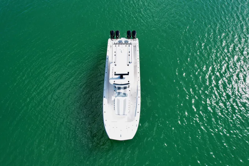 Slide: The Image of Aerial view of 2022 Invincible 40 Catamaran on clear green water. - 3