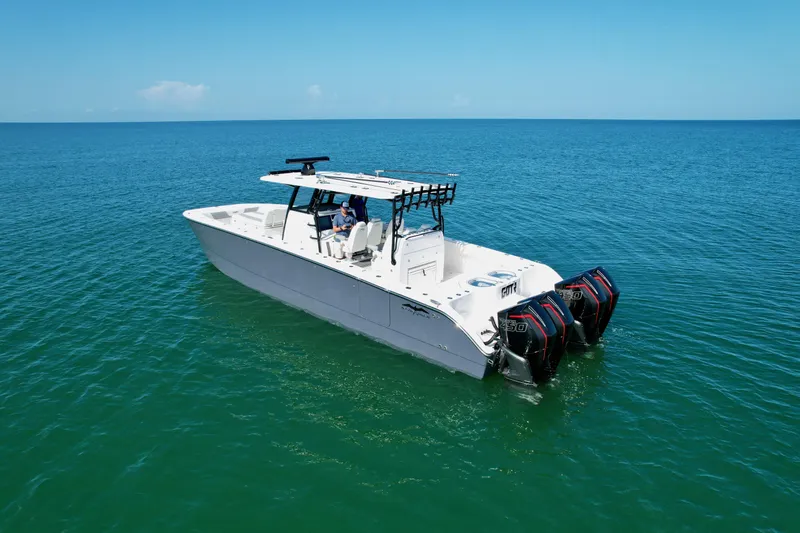 Slide: The Image of 2022 Invincible 40 Catamaran on open water with triple outboard engines. - 30