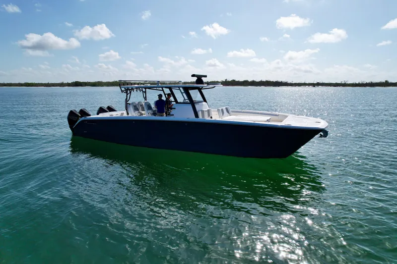 Slide: The Image of 2022 Invincible 40 Catamaran on calm waters under a clear sky. - 33