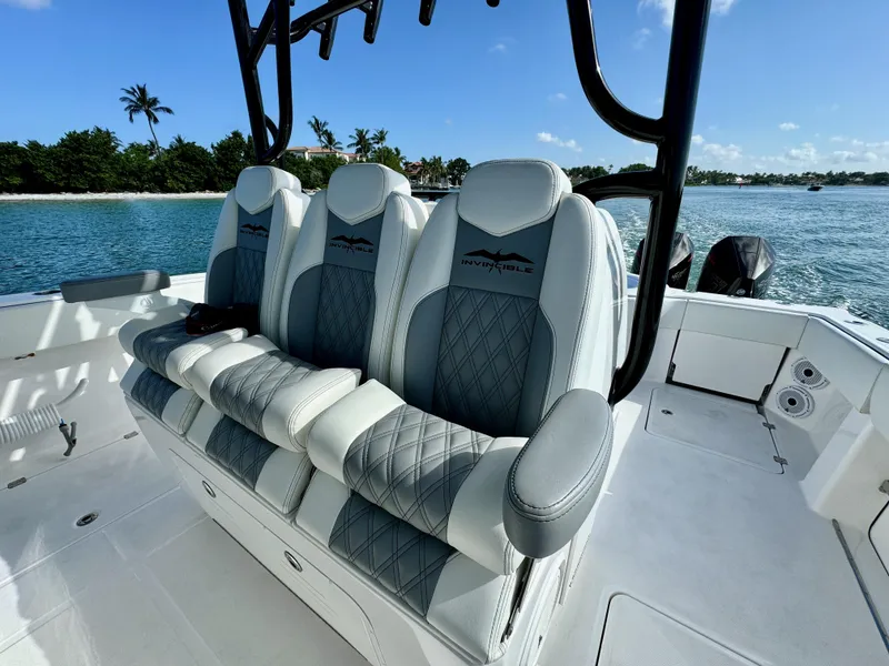 Slide: The Image of Luxurious seating on a 2022 Invincible 40 Catamaran with ocean backdrop. - 8