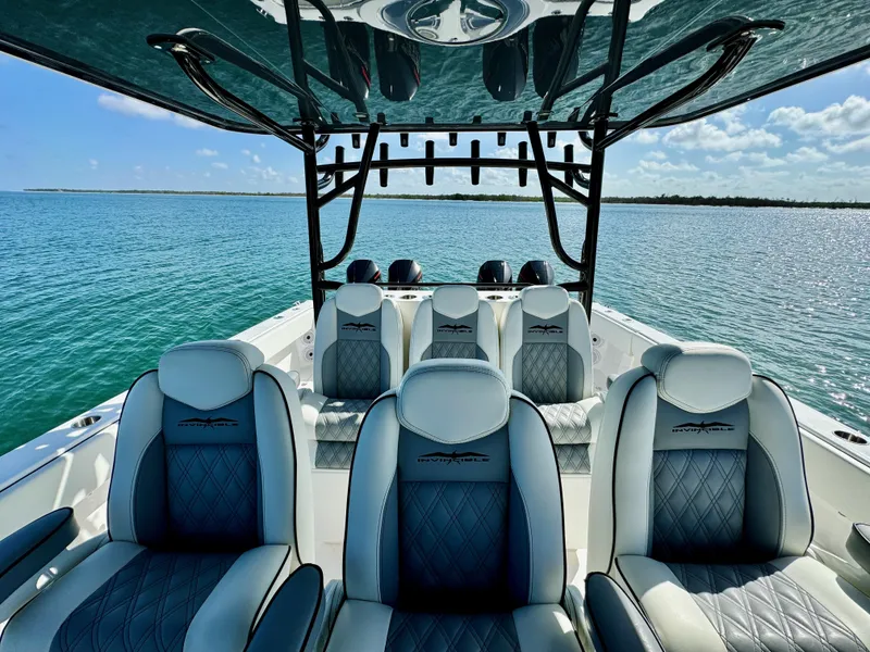 Slide: The Image of 2022 Invincible 40 Catamaran interior with luxurious seating on open water. - 9