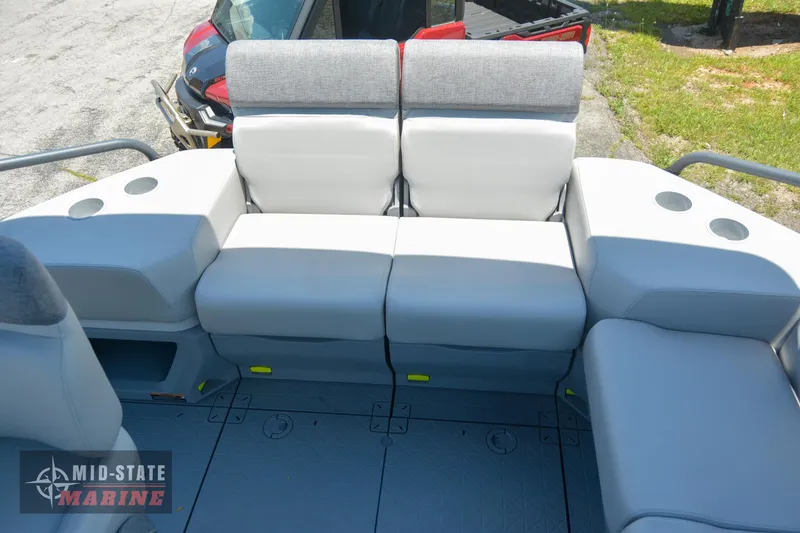 Slide: The Image of 2023 Sea-Doo Switch Sport 21 boat seating area with gray cushions and cup holders. - 11