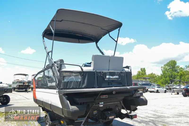 Slide: The Image of 2023 Sea-Doo Switch Sport 21 pontoon boat with canopy in a parking lot. - 4