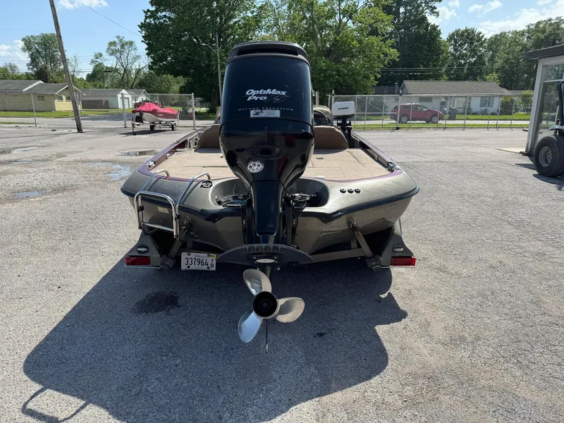 Slide: The Image of 2001 Ranger 520DVX Comanche boat with Optimax Pro motor in a parking lot. - 10