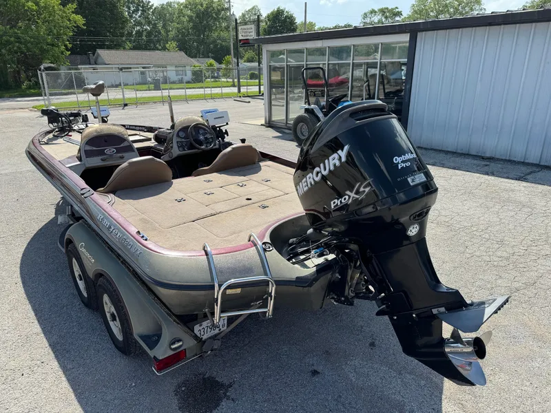 Slide: The Image of 2001 Ranger 520DVX Comanche boat with Mercury Pro XS engine, parked outdoors. - 2
