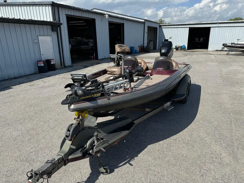 Slide: The Image of 2001 Ranger 520DVX Comanche boat parked outside metal garages on a sunny day. - 4