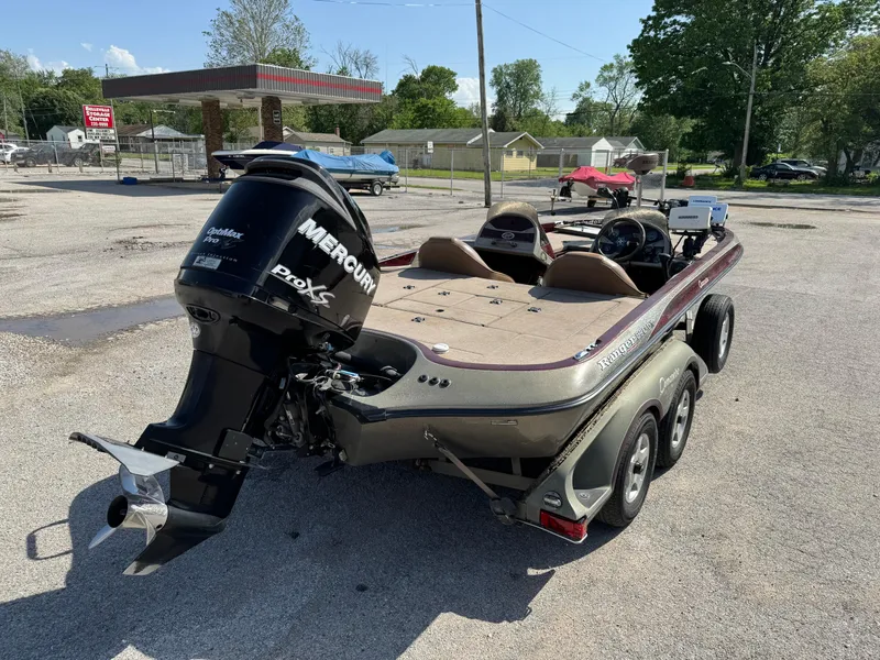 Slide: The Image of 2001 Ranger 520DVX Comanche boat with Mercury Pro XS engine in a parking lot. - 5