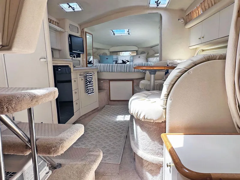 Slide: The Image of Interior of 1999 Sea Ray 340 Sundancer yacht, featuring cozy seating and modern amenities. - 1