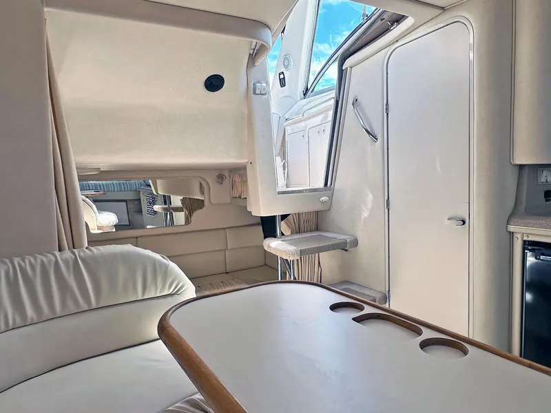 Slide: The Image of Interior of 1999 Sea Ray 340 Sundancer yacht, featuring seating and table. - 2