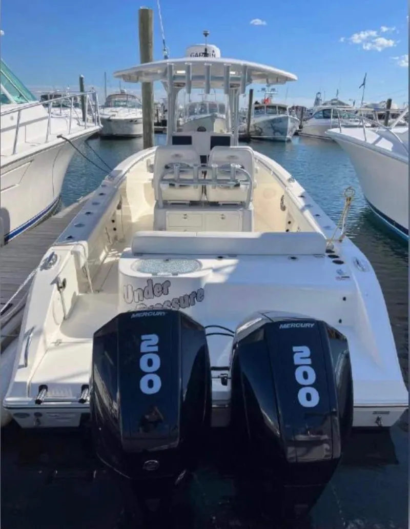 Slide: The Image of 2021 Cobia 262 Center Console boat with twin Mercury 200 engines docked at marina. - 5