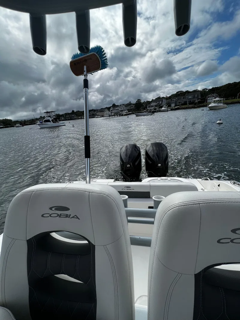 Slide: The Image of 2021 Cobia 262 Center Console boat on water, view from behind seats. - 7