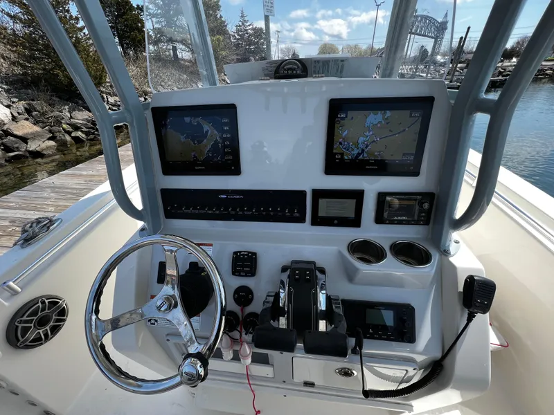 Slide: The Image of 2021 Cobia 262 Center Console boat helm with dual Garmin displays and steering wheel. - 9