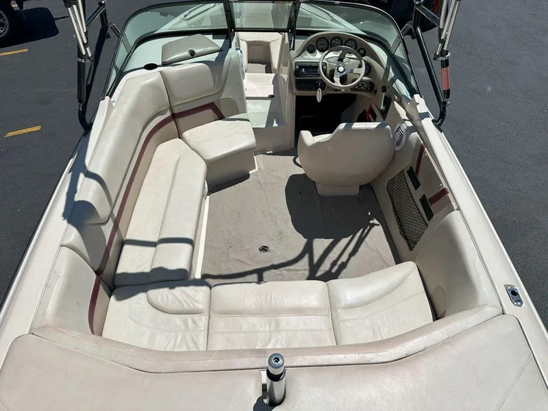 Slide: The Image of 1999 Centurion Elite-V C4 boat interior with beige seating and steering wheel. - 12
