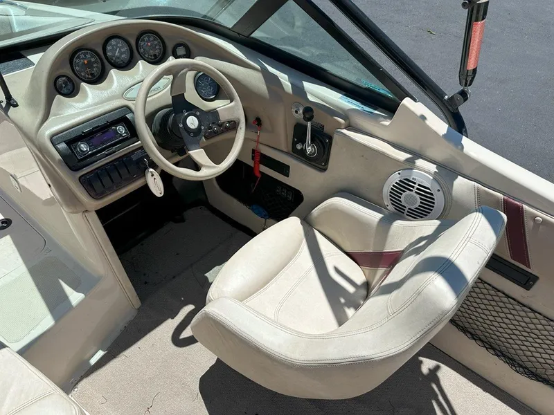 Slide: The Image of Interior of a 1999 Centurion Elite-V C4 boat showing steering wheel and dashboard controls. - 14
