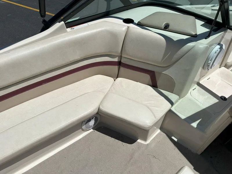 Slide: The Image of 1999 Centurion Elite-V C4 boat interior with beige seating and maroon accents. - 15