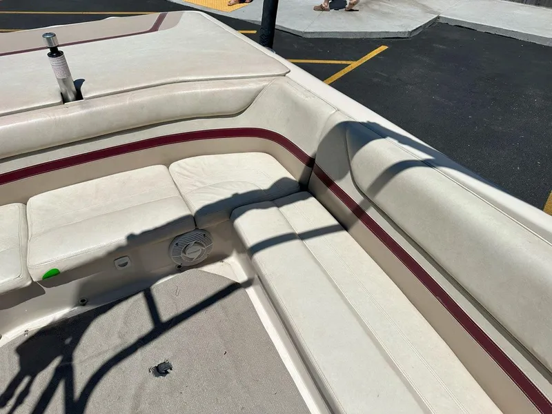 Slide: The Image of 1999 Centurion Elite-V C4 boat interior with beige seating and maroon accents. - 16