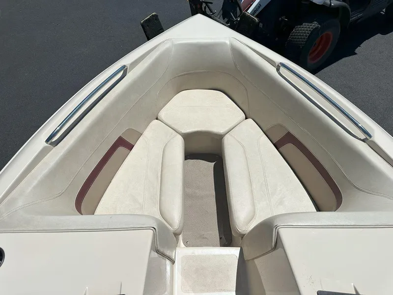 Slide: The Image of 1999 Centurion Elite-V C4 boat interior with beige seating and metal handrails. - 19