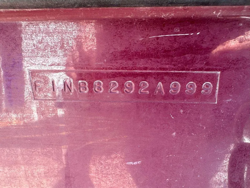 Slide: The Image of 1999 Centurion Elite-V C4 hull identification number on maroon surface. - 23