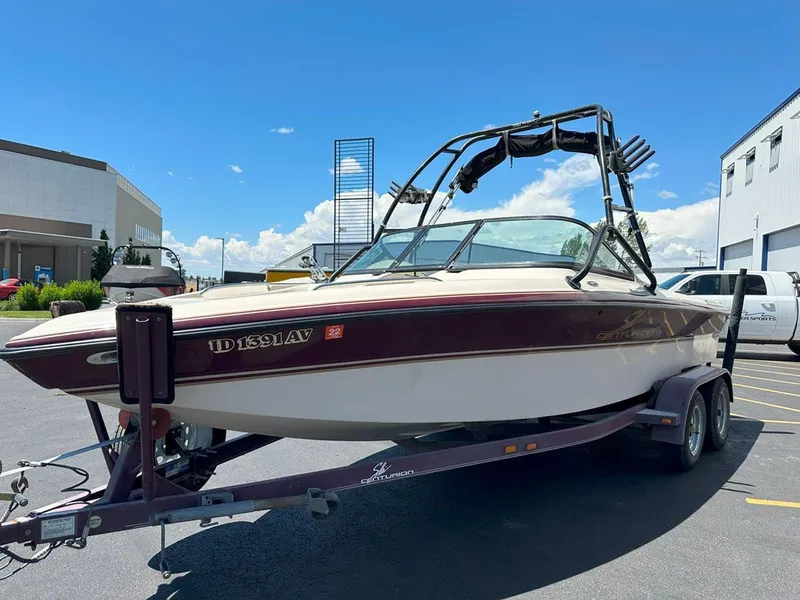 Slide: The Image of 1999 Centurion Elite-V C4 boat on trailer, parked outdoors under a clear blue sky. - 4