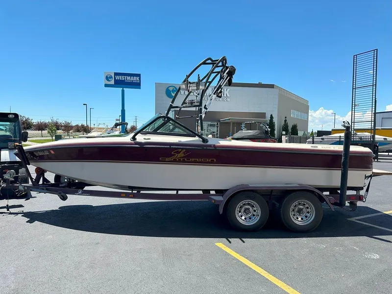 Slide: The Image of 1999 Centurion Elite-V C4 boat on trailer in parking lot, sunny day. - 5