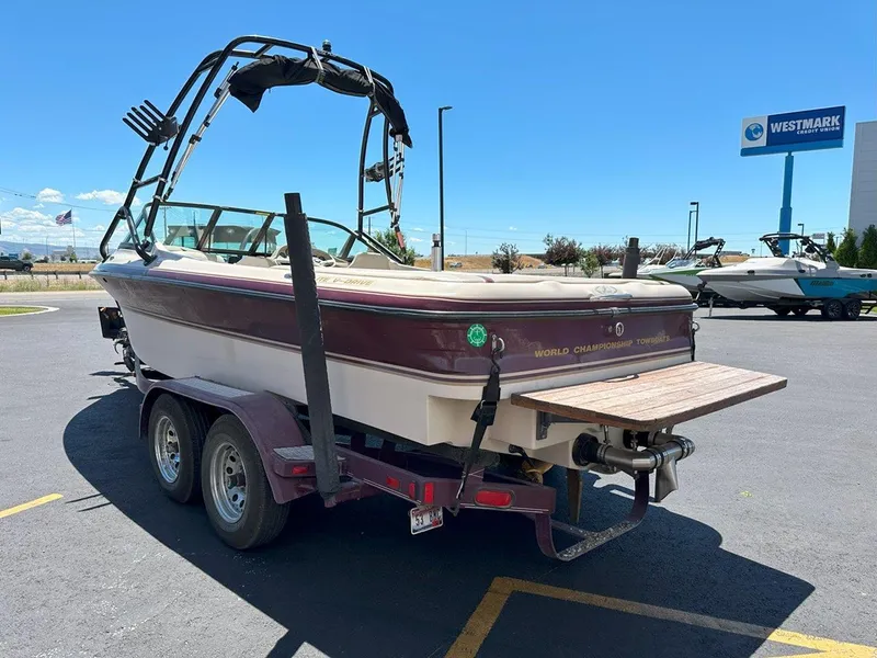 Slide: The Image of 1999 Centurion Elite-V C4 boat on trailer in parking lot, sunny day. - 6