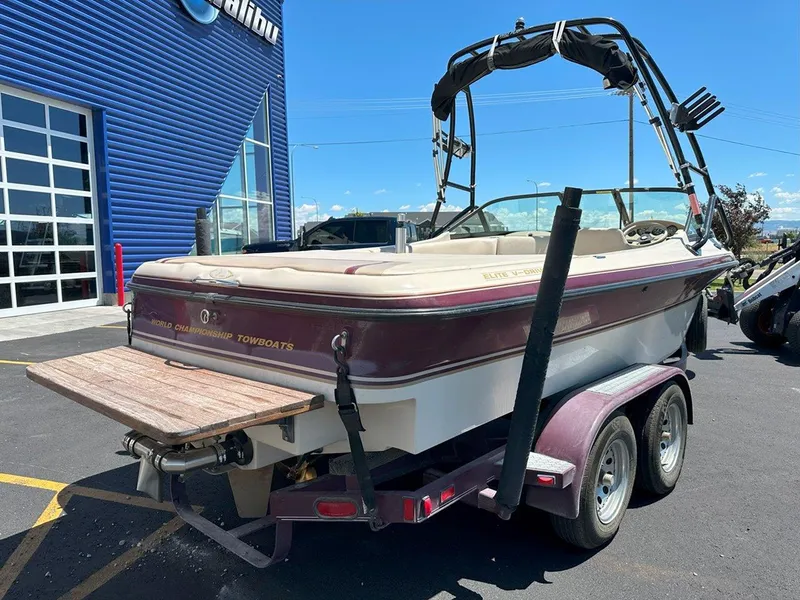 Slide: The Image of 1999 Centurion Elite-V C4 boat on trailer outside dealership. - 8