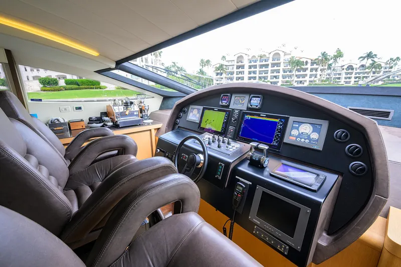Slide: The Image of Cockpit of 2009 Pershing 90 Express yacht with advanced navigation systems and luxurious seating. - 14