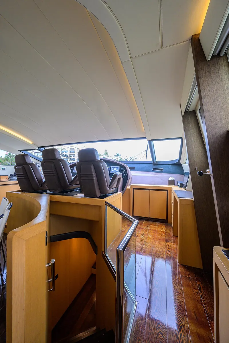 Slide: The Image of Interior of 2009 Pershing 90 Express yacht with luxurious seating and polished wood flooring. - 15