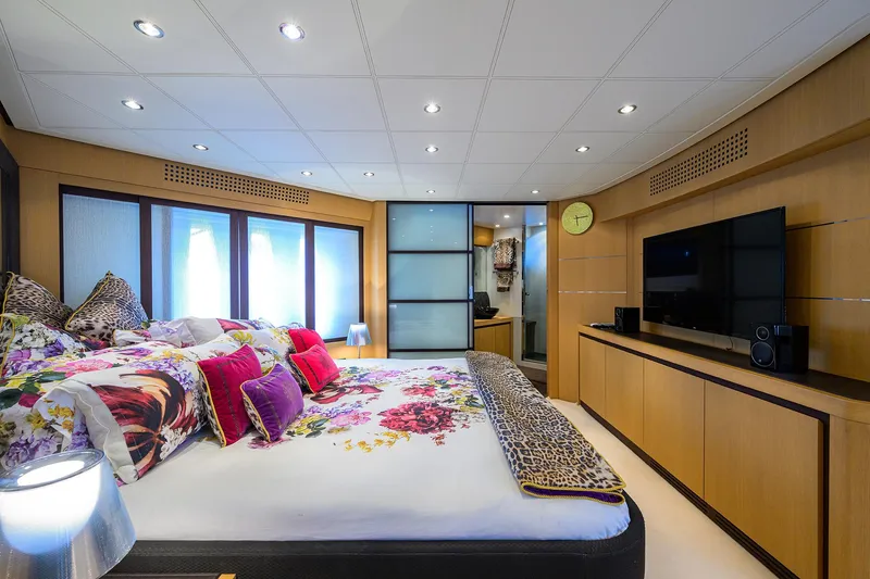 Slide: The Image of Luxurious bedroom interior of 2009 Pershing 90 Express yacht with modern decor and floral bedding. - 21