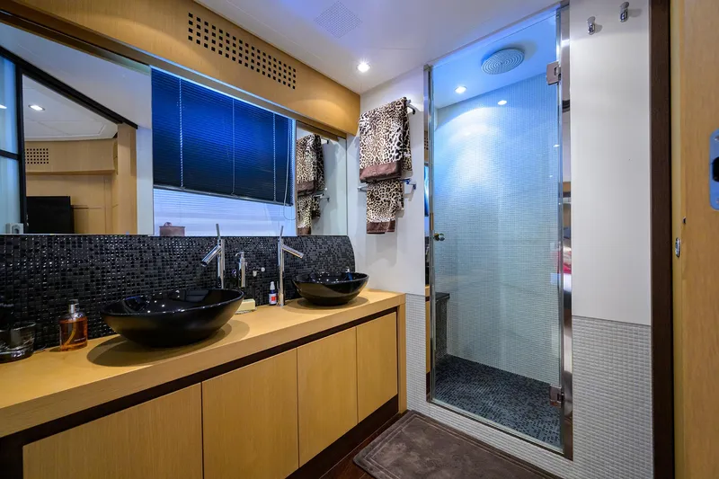 Slide: The Image of Luxurious bathroom in 2009 Pershing 90 Express yacht with dual sinks and glass shower. - 24