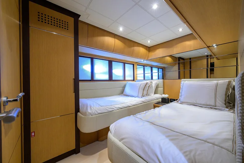 Slide: The Image of Luxurious twin bedroom on 2009 Pershing 90 Express yacht with modern wood paneling. - 29